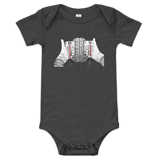 A Dark Grey Heather short-sleeve baby one-piece with a graphic print of hands holding defibrillators on a brain. The left paddle says "DOPAMINE" and the right paddle says "SEROTONIN".