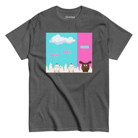 A dark heather women's t-shirt featuring a cartoon graphic. Two white baby chickens are labeled 'DUCK' and 'DUCK', followed by a brown moose labeled 'GOOSE'. The background is split between blue sky and pink.