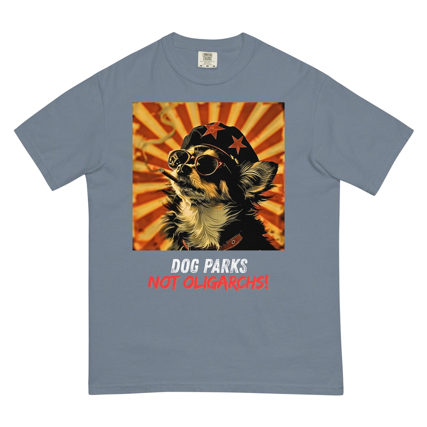 A blue jean colored women's t-shirt with a graphic of a Chihuahua wearing sunglasses and a beret against a 50's style propaganda background with bold all-caps text underneath that reads "DOG PARKS NOT OLIGARCHS".