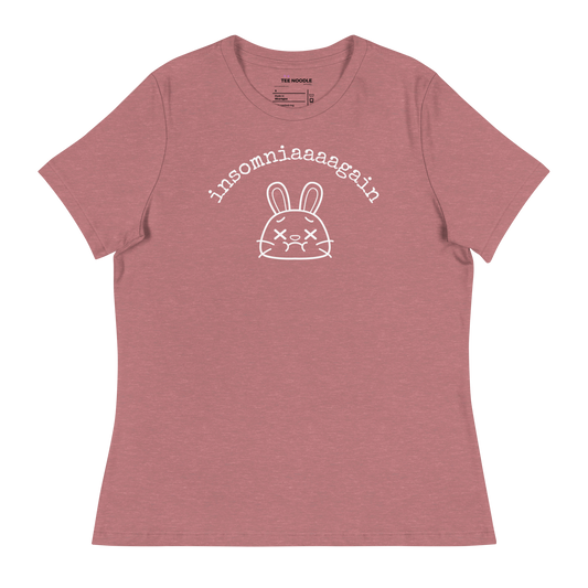 A heather mauve women's relaxed t-shirt featuring a cartoon bunny with tired eyes and the text 'insomniaaaagain'.