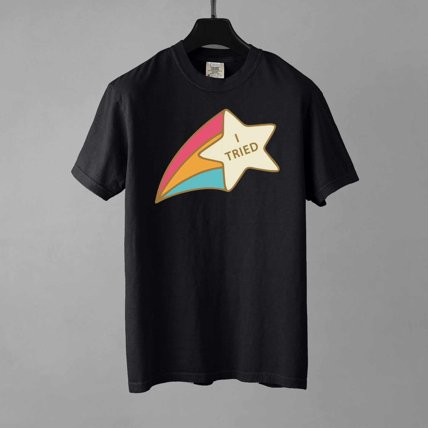 Black t-shirt with a colorful star graphic and 'I Tried' text on a gray background