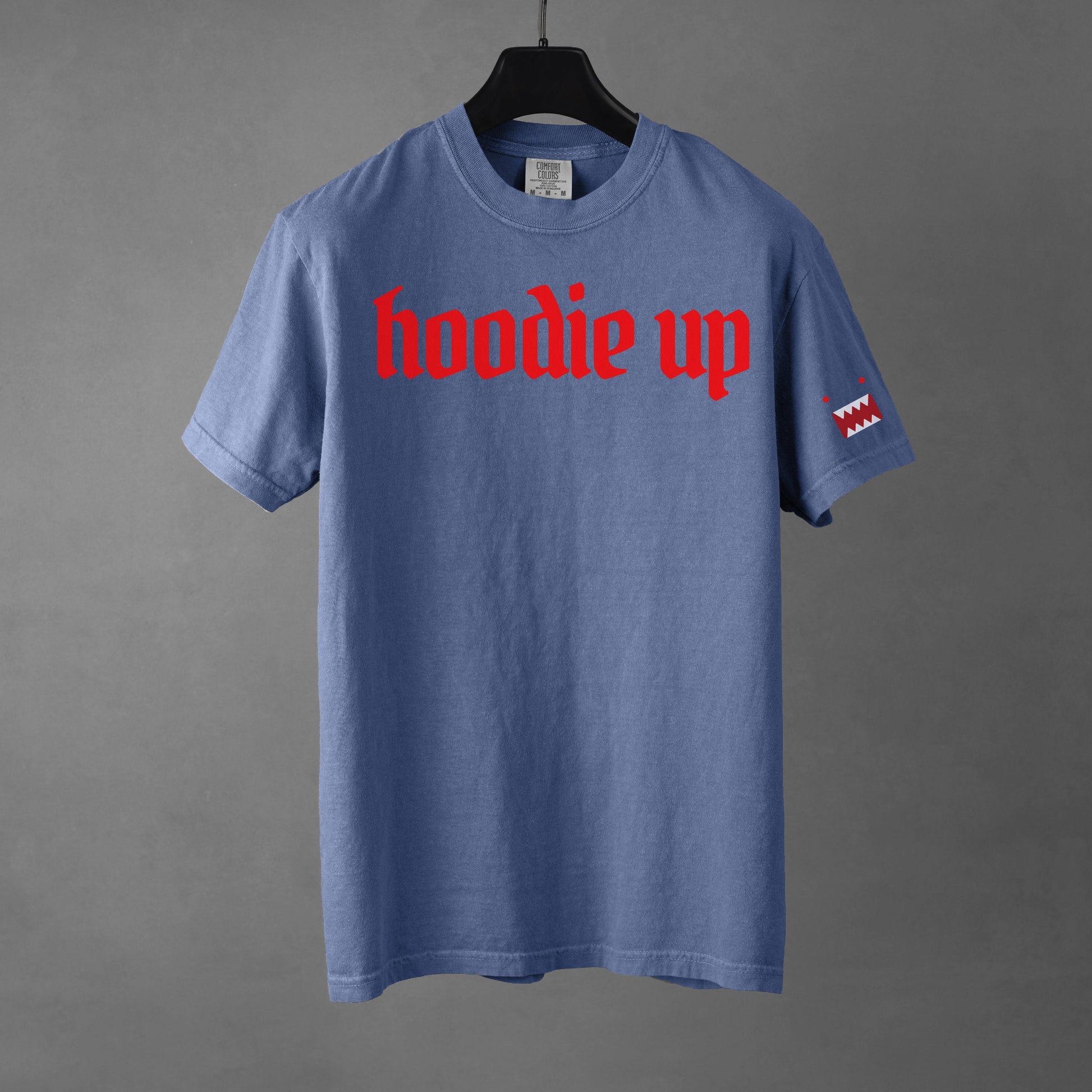 Blue t-shirt with red text 'hoodie up' on a gray background