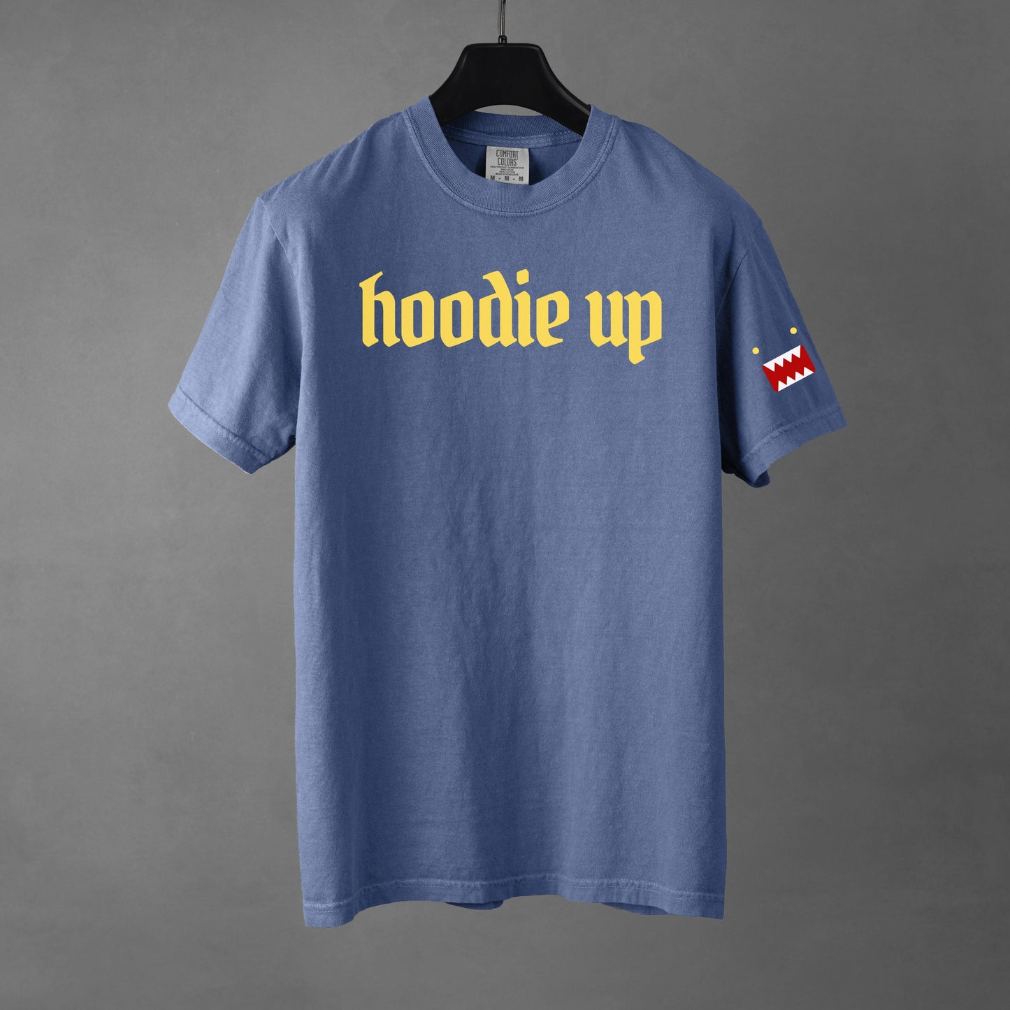 Blue t-shirt with 'hoodie up' text and graphic on a gray background