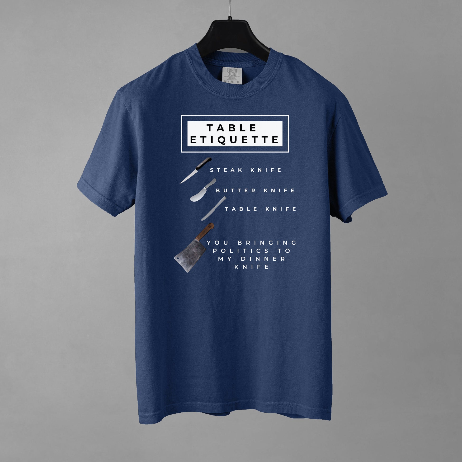 Blue t-shirt with table etiquette graphic on a gray background