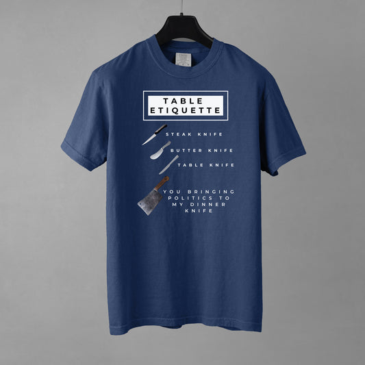 Blue t-shirt with table etiquette graphic on a gray background