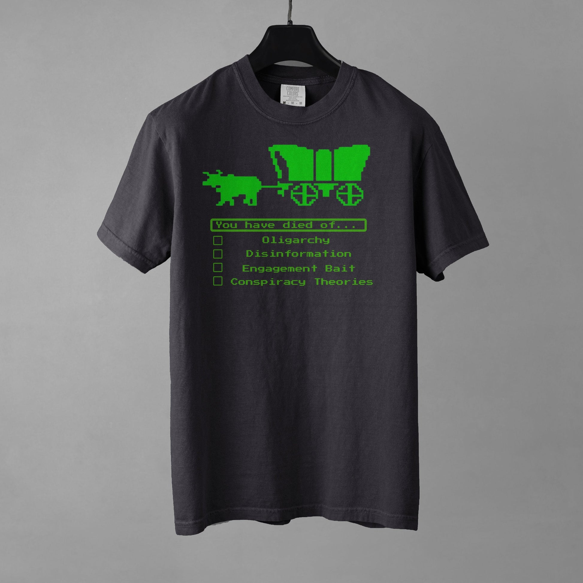 Graphite colored t-shirt with green graphic and text on a gray background