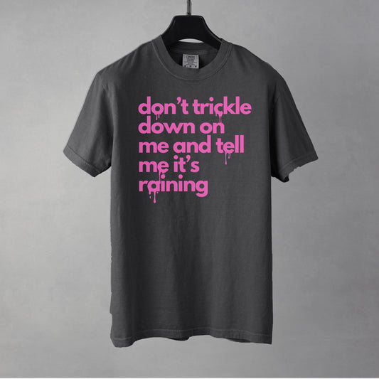 A pepper colored t-shirt with pink text on a gray background