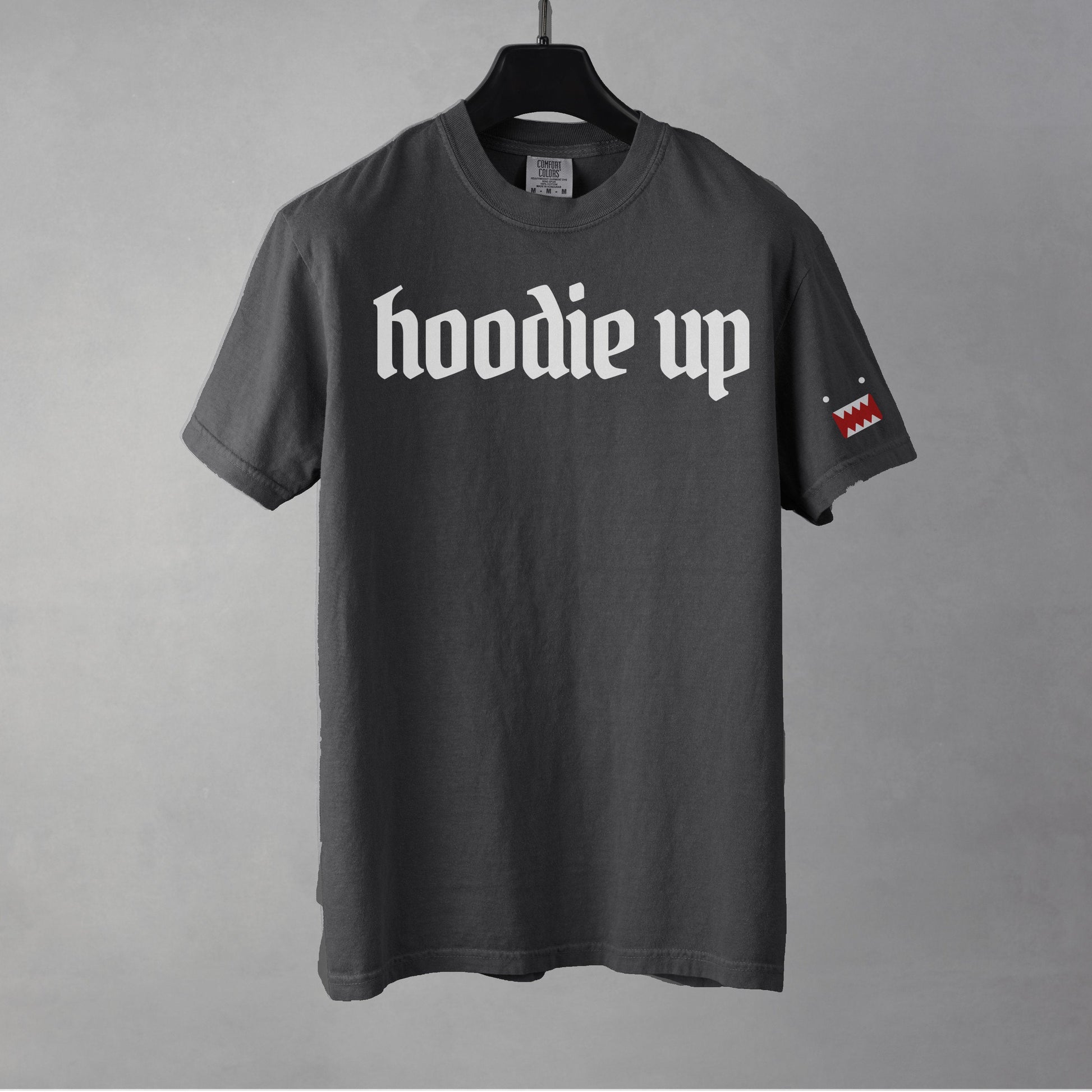 A pepper colored t-shirt with 'hoodie up' text on a gray background