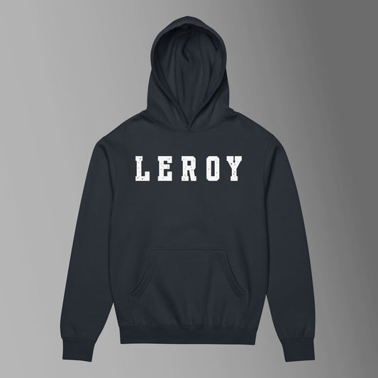 A navy blue pullover hoodie featuring the name 'LEROY' printed horizontally across the chest in large, distressed white collegiate block letters. The hoodie includes a front kangaroo pocket and a ribbed waist and cuffs.