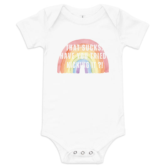 A White short-sleeve baby one-piece with a colorful rainbow design and text that reads 'THAT SUCKS HAVE YOU TRIED KICKING IT'.