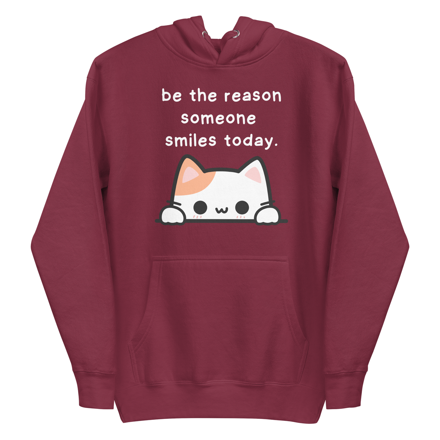 A maroon women's premium hoodie featuring a graphic of a cute white and orange cat peeking over a ledge. Above the cat is the text 'be the reason someone smiles today'.