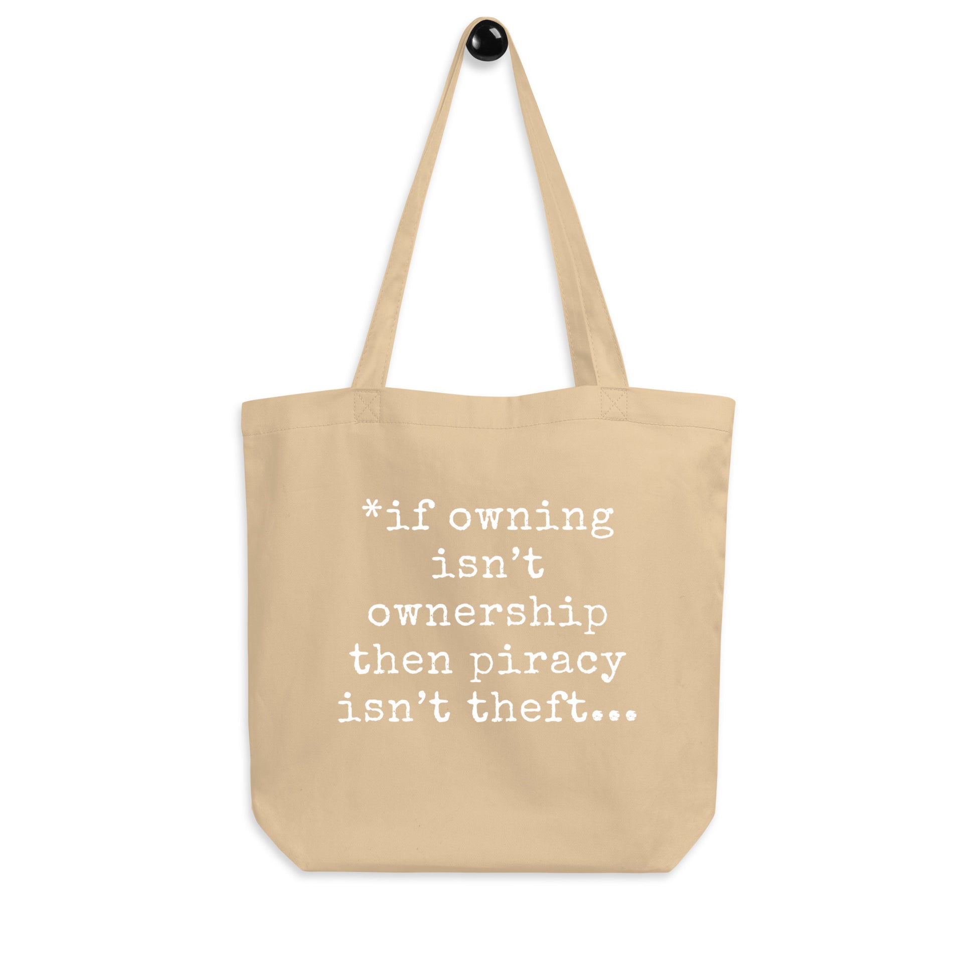 A tan organic cotton tote bag featuring the text quote 'If owning isn't ownership then piracy isn't theft' regarding digital rights.