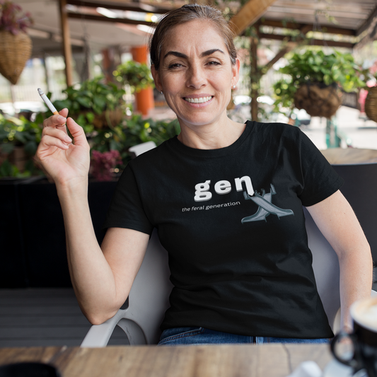 Woman wearing a black t-shirt with 'Gen X' text, sitting at an outdoor cafe.