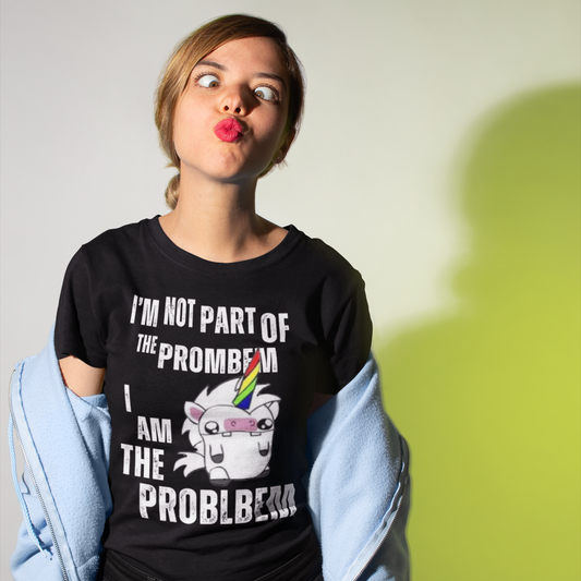 A woman making a cross-eyed, duck lip funny face wearing a hoodie off her shoulders and a black colored t-shirt with a derpy unicorn graphic and text bold all-caps text with intentional misspellings that reads 'I'M NOT PART OF THE PROMBEM I AM THE PROBLBEM'. 
