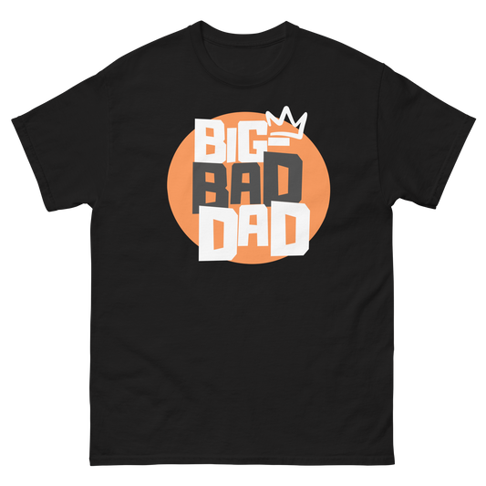 A black t-shirt featuring a large orange circle graphic with the text 'BIG BAD DAD' in stacked block letters, topped with a white crown.