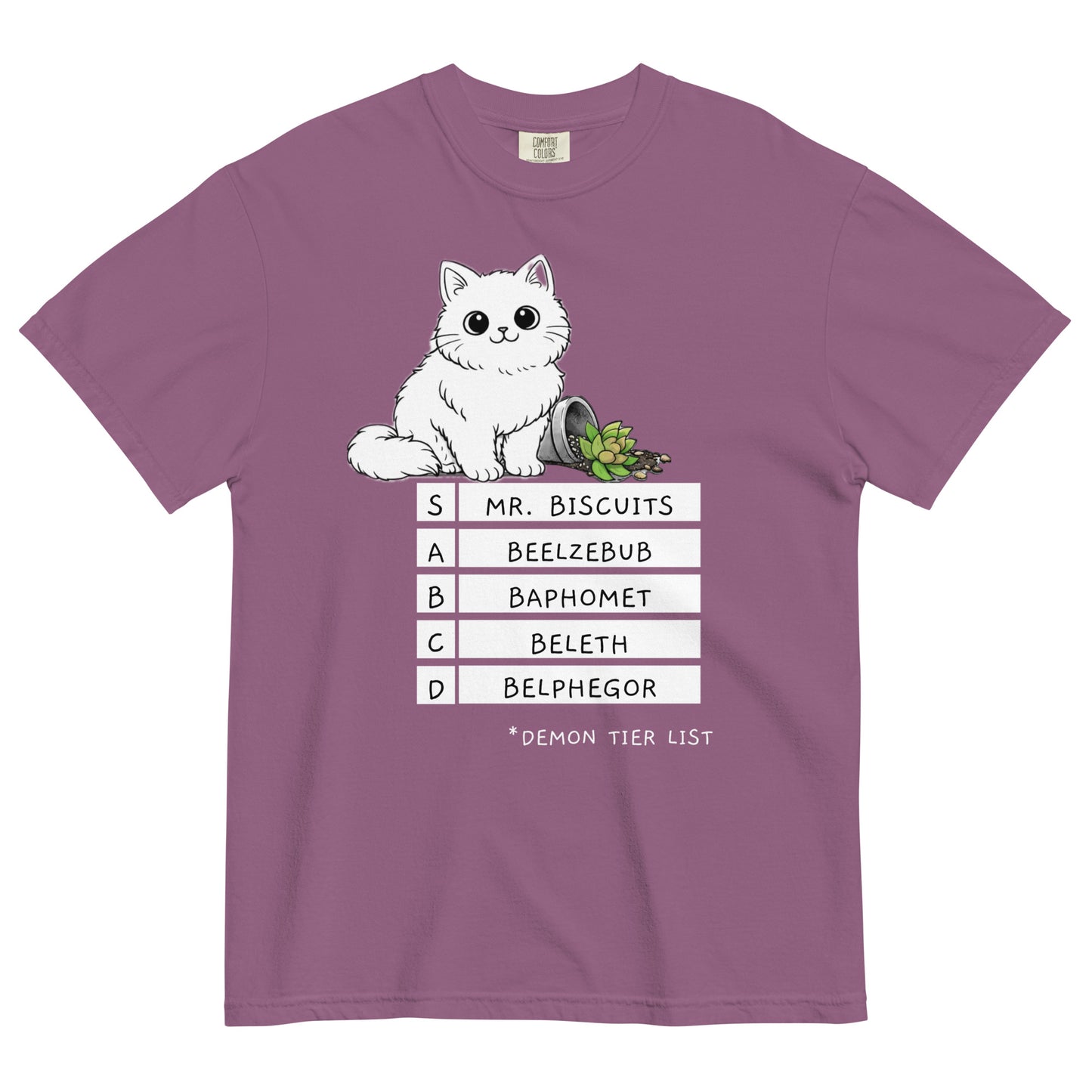 A berry colored t-shirt with a graphic of a white, fluffy kitten standing behind a knocked over plant. Beneath the cat is a 'Demon Tier List' with the cat 'Mr. Biscuits' listed atop the list in the S tier position.