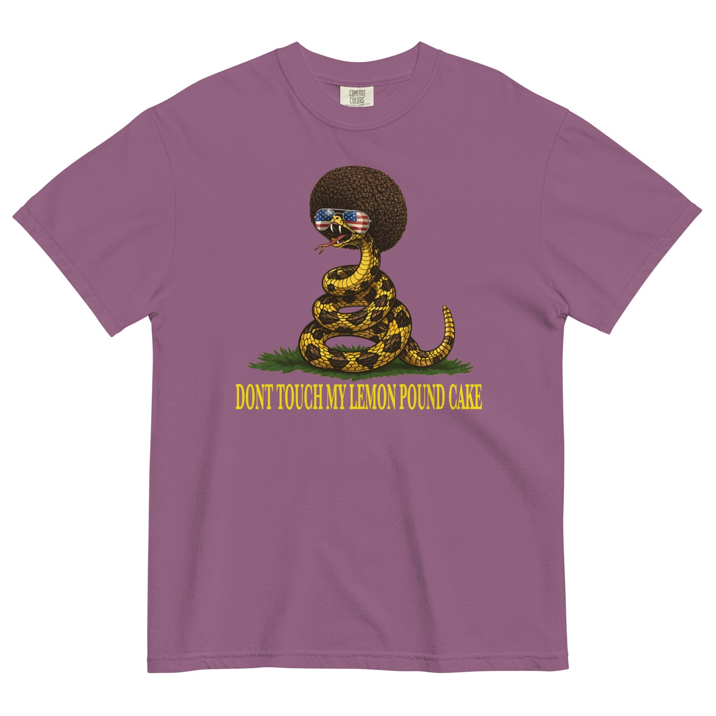 A berry colored graphic t-shirt featuring a coiled rattlesnake with a large brown afro and flag-mirrored sunglasses above yellow text that reads "DONT TOUCH MY LEMON POUND CAKE."