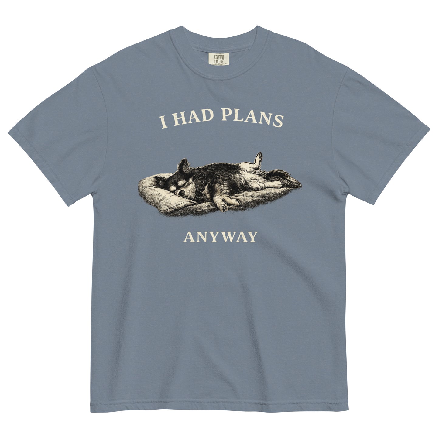 A blue jean colored t-shirt featuring a monochrome illustration of a long-haired Chihuahua sleeping deeply on its back in a dog bed, with rear legs splayed open and forepaws crossed. Above the illustration in bold, white capital letters is the text 'I HAD PLANS', and below it reads 'ANYWAY'.