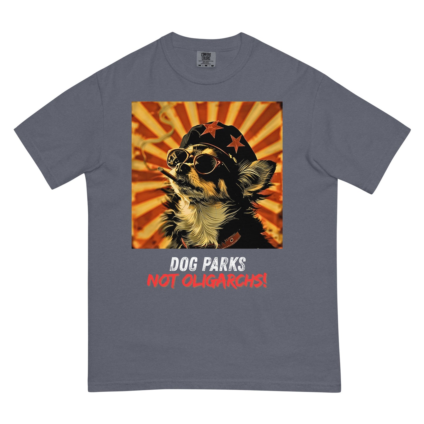A denim colored men's t-shirt with a graphic of a Chihuahua wearing sunglasses and a beret against a 50's style propaganda background with bold all-caps text underneath that reads "DOG PARKS NOT OLIGARCHS".