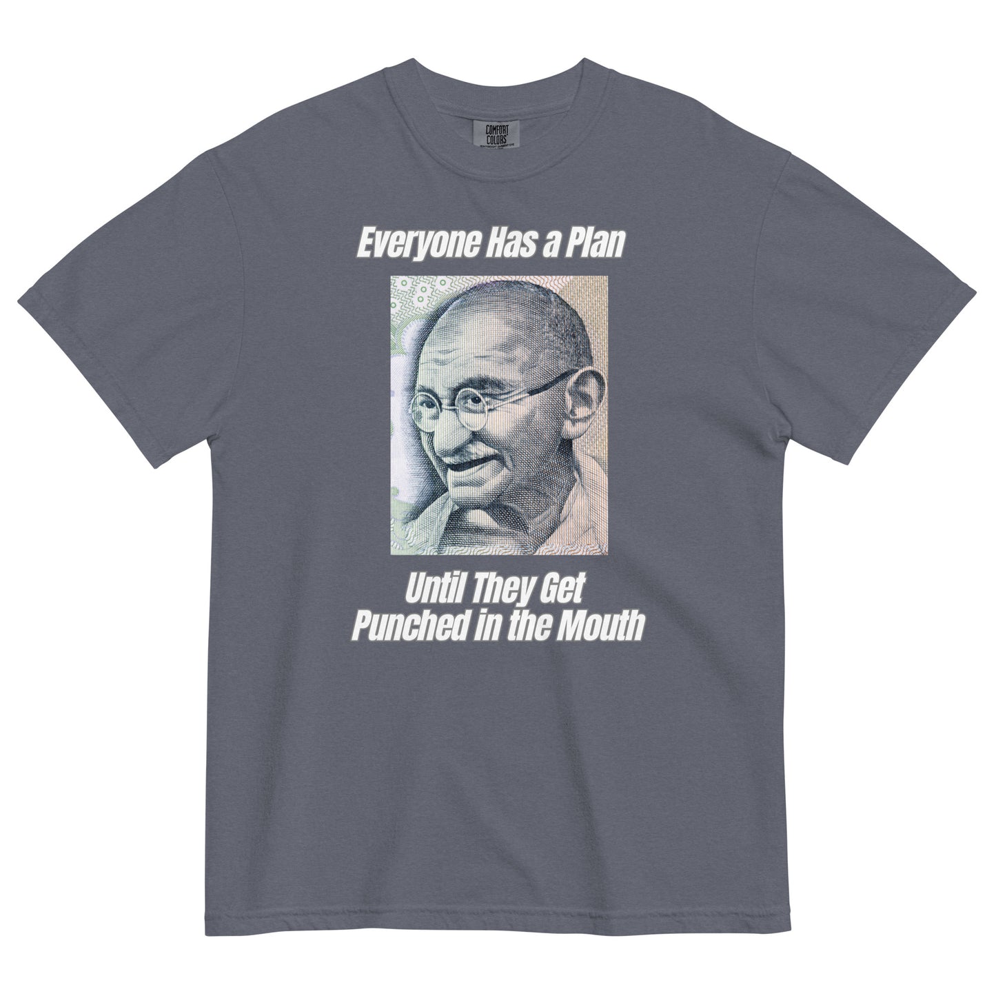 A denim colored t-shirt featuring a vintage portrait of Mahatma Gandhi ironically paired with the famous quote 'Everyone Has a Plan Until They Get Punched in the Mouth'