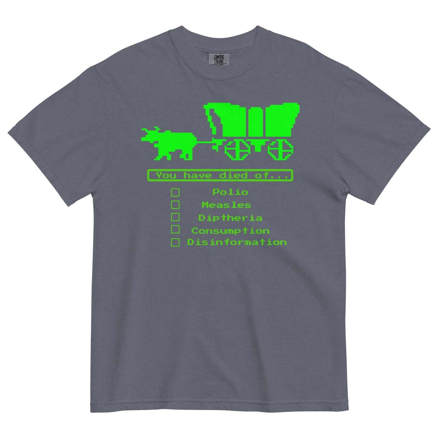 A denim blue short-sleeve crewneck t-shirt featuring a bright green, retro 8-bit pixel graphic. The design shows an ox pulling a covered wagon above a text box that reads 'You have died of...'. Below the text is a checklist with empty square boxes next to the words 'Polio', 'Measles', 'Diptheria', 'Consumption', and 'Disinformation'