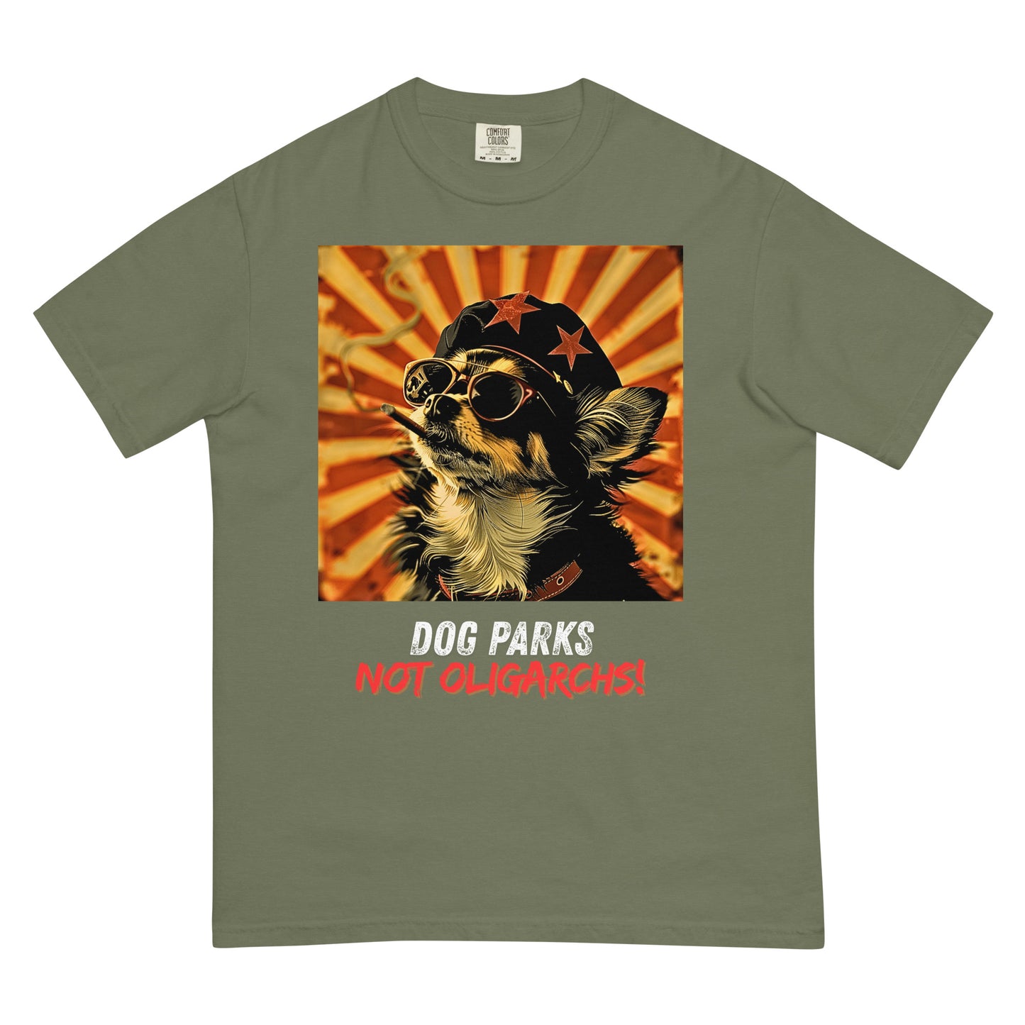 A moss green colored women's t-shirt with a graphic of a Chihuahua wearing sunglasses and a beret against a 50's style propaganda background with bold all-caps text underneath that reads "DOG PARKS NOT OLIGARCHS".