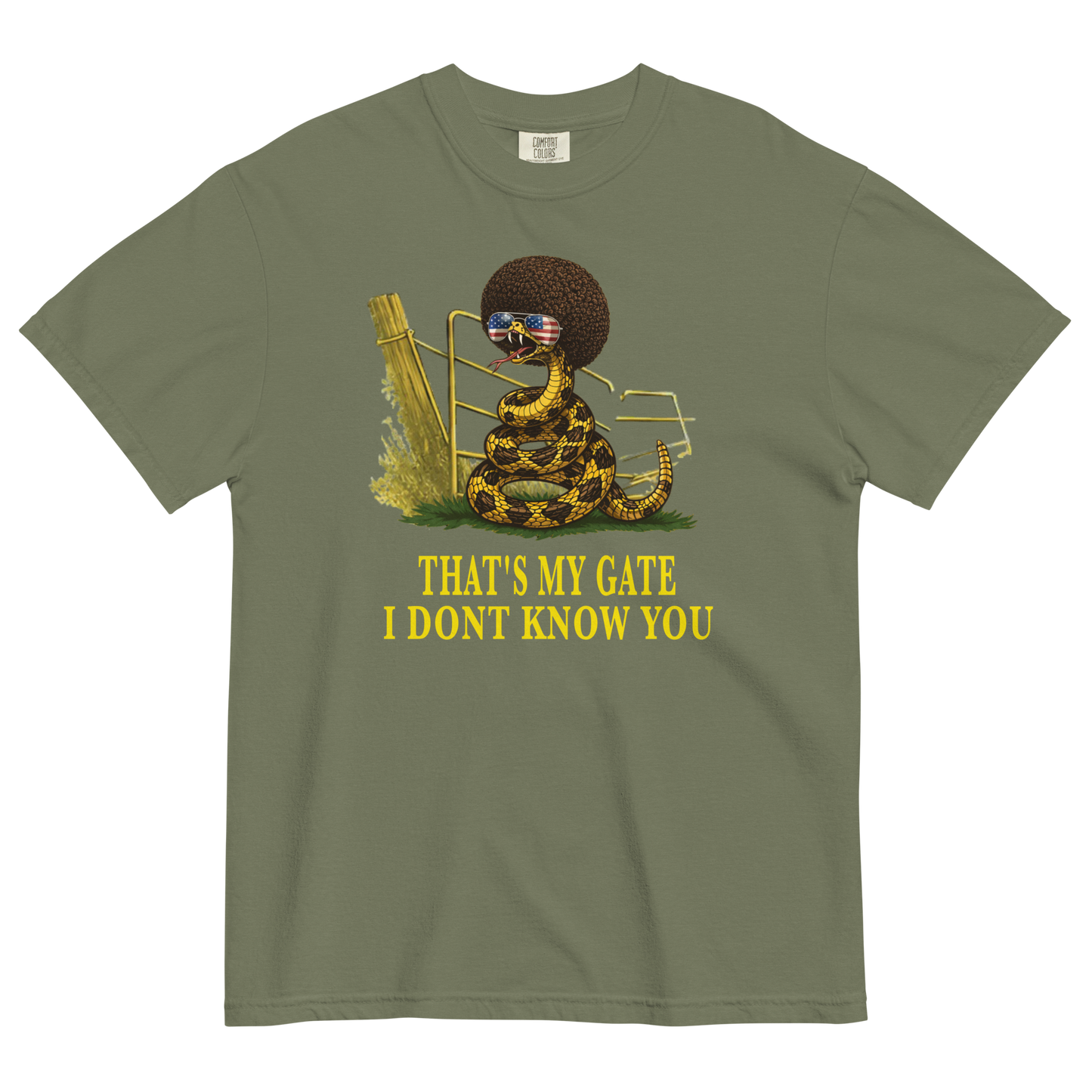 A moss colored graphic t-shirt featuring a coiled rattlesnake, in front of a broken gate, with a large brown afro and flag-mirrored sunglasses above yellow text that reads "THAT'S MY GATE I DONT KNOW YOU."