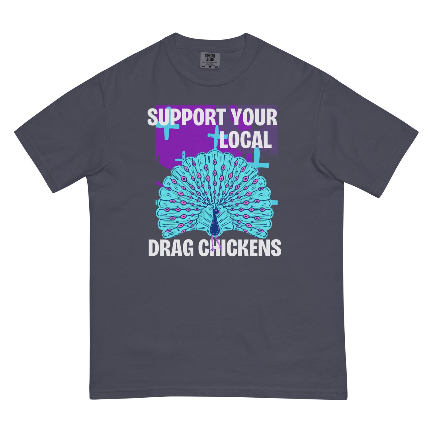 A navy colored short-sleeve crewneck t-shirt featuring a stylized graphic of a peacock with its tail feathers fully fanned out. The peacock is light blue with pink eye details, set against a distressed purple background block with light blue plus signs. Above the peacock is bold white text reading 'SUPPORT YOUR LOCAL', and below it reads 'DRAG CHICKENS'.