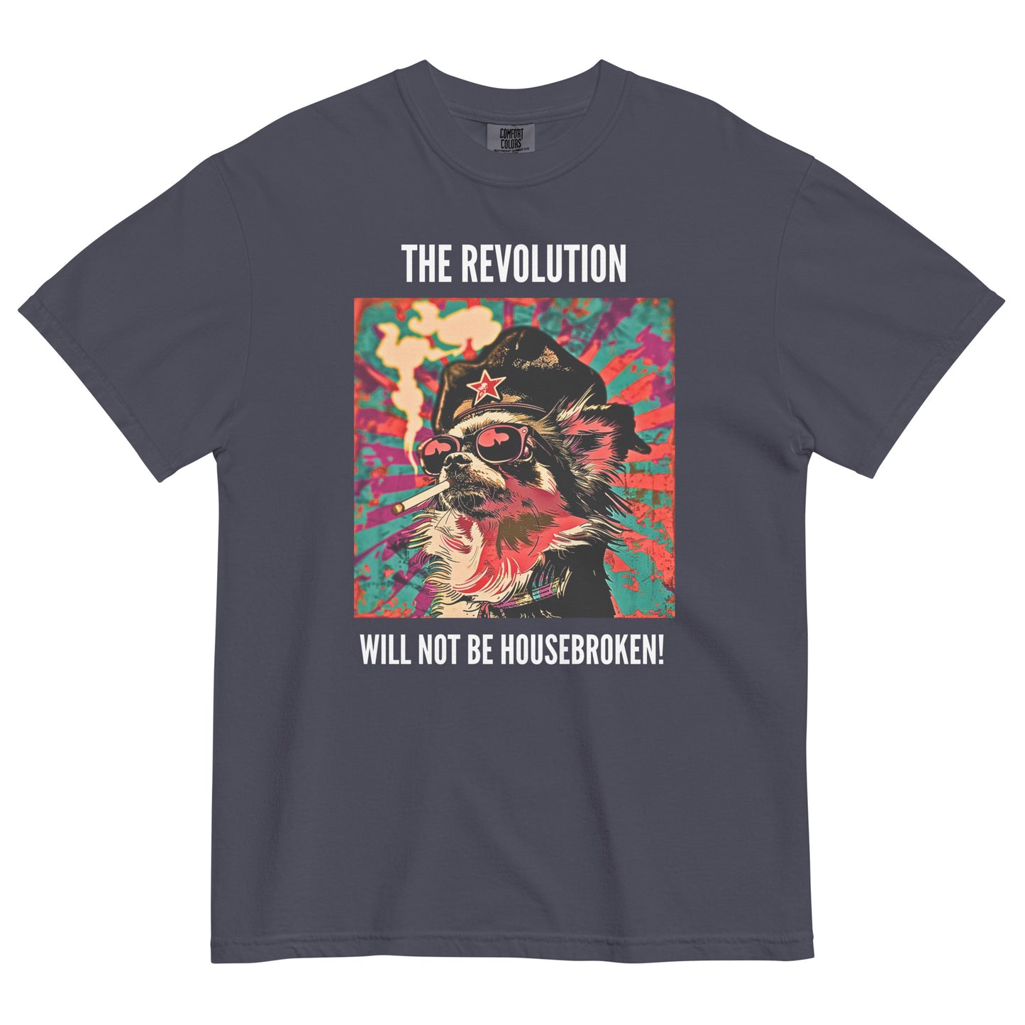 A navy colored short-sleeve crewneck t-shirt featuring a vibrant, pop-art style square graphic on the chest. The illustration shows a long-haired Chihuahua stylized as a revolutionary, wearing a black hat with a red star, red-tinted sunglasses, and smoking a cigarette, set against a colorful, grunge-textured teal and red sunburst background. Above the graphic in white capital letters is the text 'THE REVOLUTION', and below it reads 'WILL NOT BE HOUSEBROKEN!'.