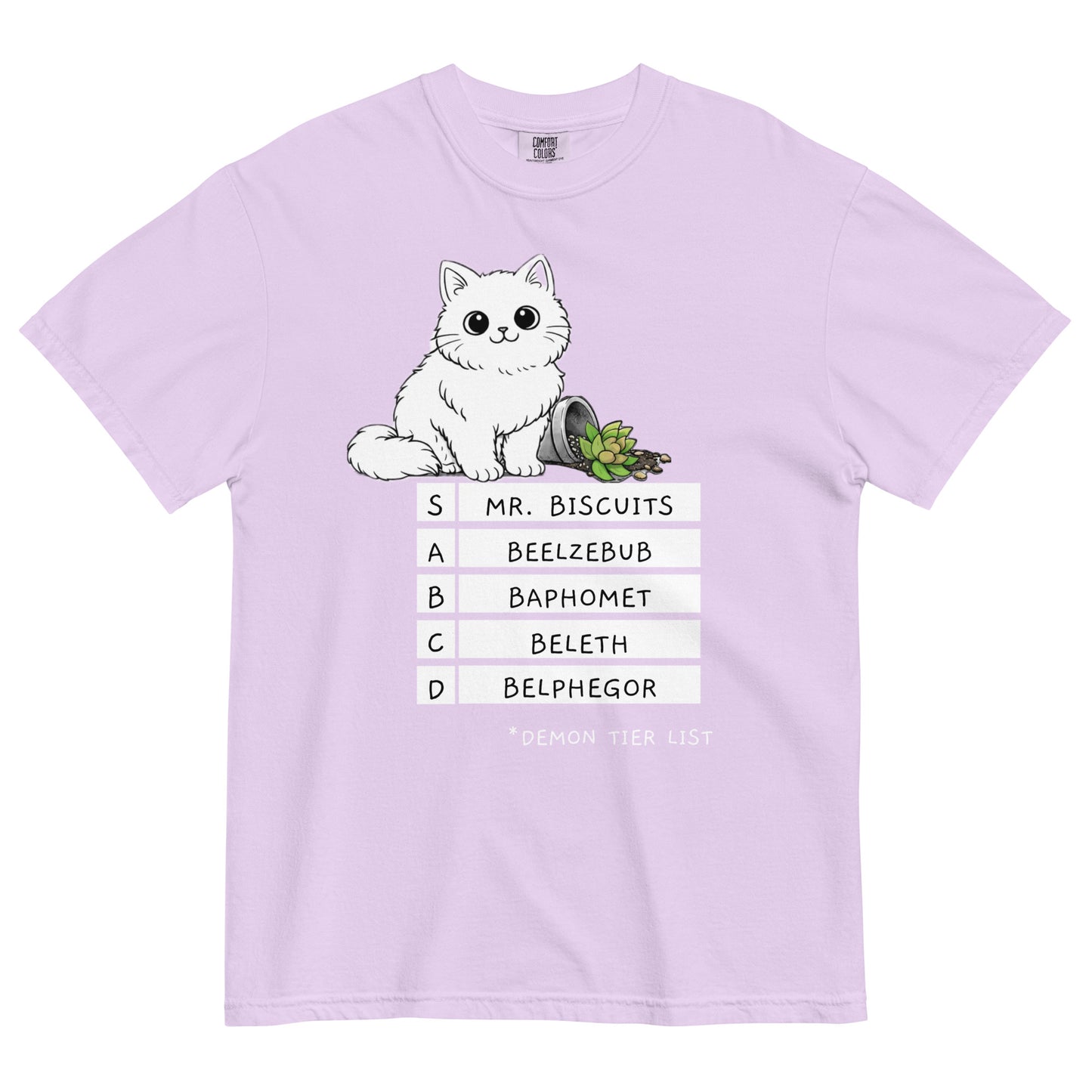 An orchid pink colored t-shirt with a graphic of a white, fluffy kitten standing behind a knocked over plant. Beneath the cat is a 'Demon Tier List' with the cat 'Mr. Biscuits' listed atop the list in the S tier position.