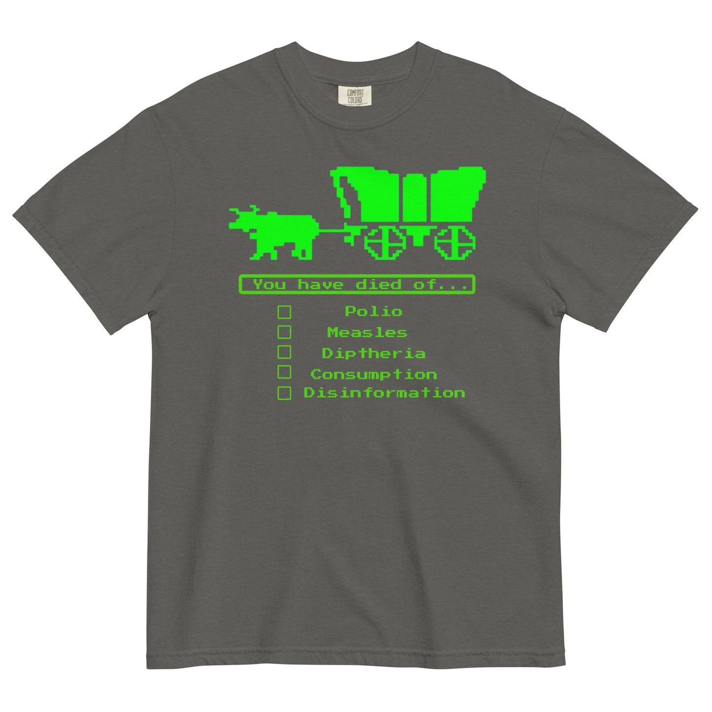 A pepper colored short-sleeve crewneck t-shirt featuring a bright green, retro 8-bit pixel graphic. The design shows an ox pulling a covered wagon above a text box that reads 'You have died of...'. Below the text is a checklist with empty square boxes next to the words 'Polio', 'Measles', 'Diptheria', 'Consumption', and 'Disinformation'