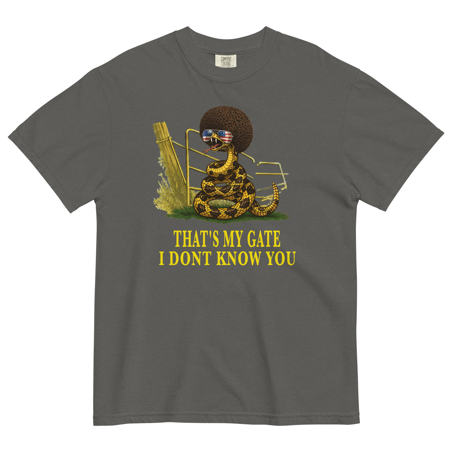 A pepper colored graphic t-shirt featuring a coiled rattlesnake, in front of a broken gate, with a large brown afro and flag-mirrored sunglasses above yellow text that reads "THAT'S MY GATE I DONT KNOW YOU."