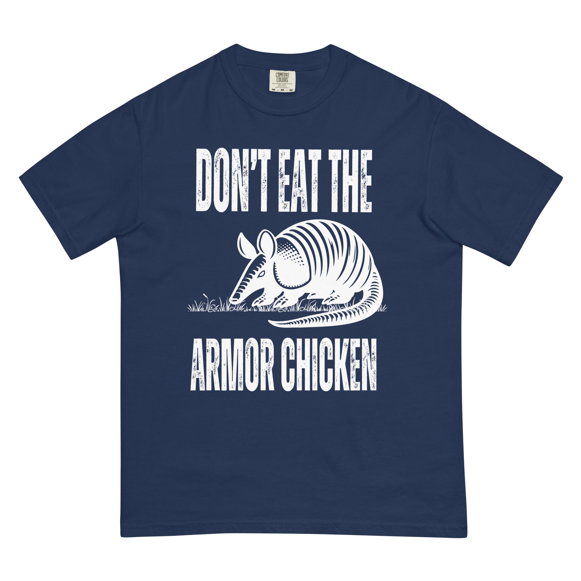 A true navy colored t-shirt with bold, all-caps, distressed white text that says 'DONT EAT THE ARMOR CHICKEN'. The text is separated into two lines by a white, line drawing graphic of an armadillo eating grass. 