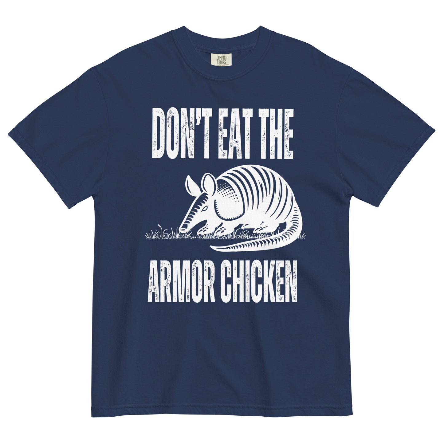 A true navy colored t-shirt with bold, all-caps, distressed white text that says 'DONT EAT THE ARMOR CHICKEN'. The text is separated into two lines by a white, line drawing graphic of an armadillo eating grass. 