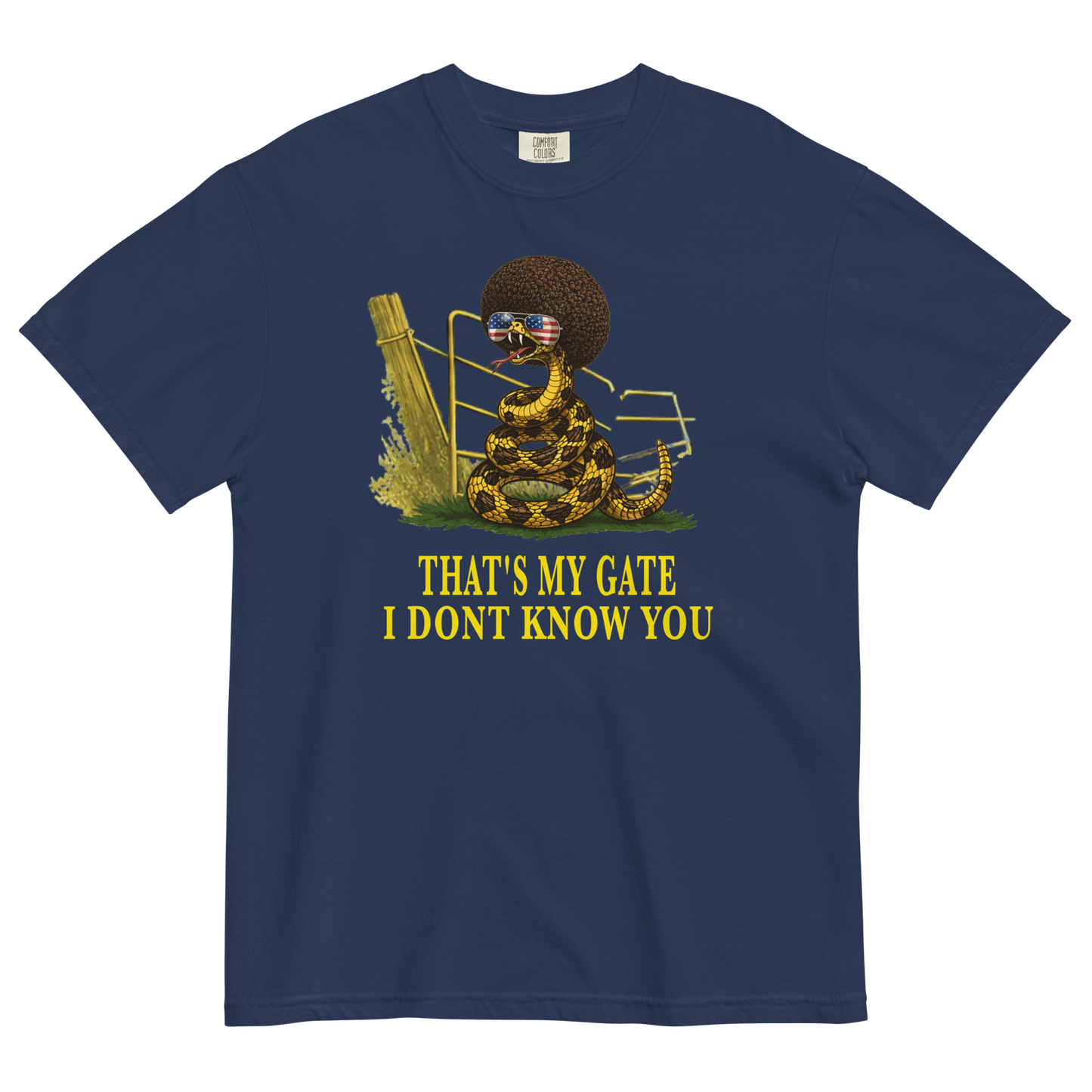 A navy colored graphic t-shirt featuring a coiled rattlesnake, in front of a broken gate, with a large brown afro and flag-mirrored sunglasses above yellow text that reads "THAT'S MY GATE I DONT KNOW YOU."