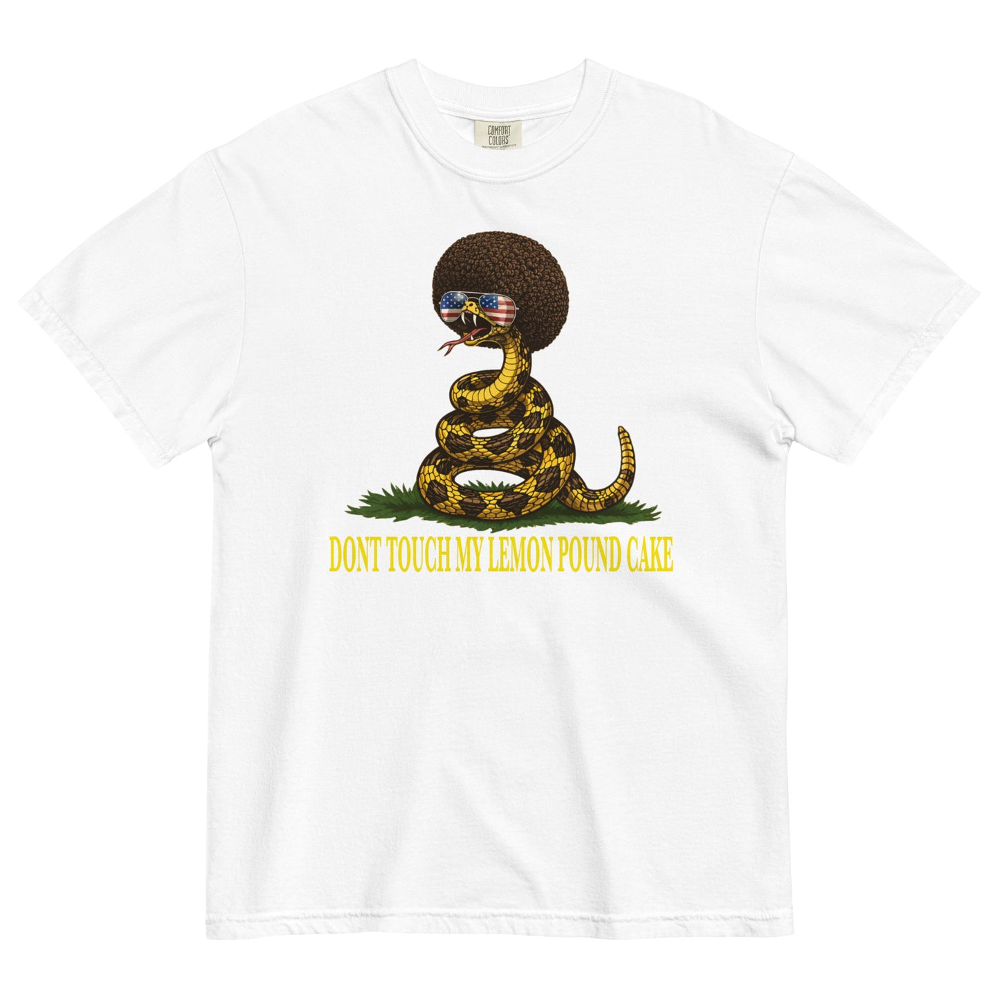 A white colored graphic t-shirt featuring a coiled rattlesnake with a large brown afro and flag-mirrored sunglasses above yellow text that reads "DONT TOUCH MY LEMON POUND CAKE."