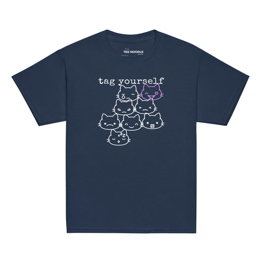 A navy kids t-shirt featuring a 'Tag Yourself' cat mood chart with the winking cat highlighted.